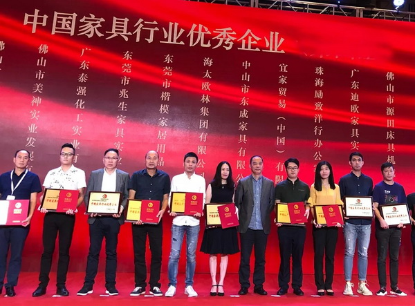 东成红木副总经理张奕海(右四)上台接受颁奖 东成红木副总经理张奕海(右四)上台接受颁奖